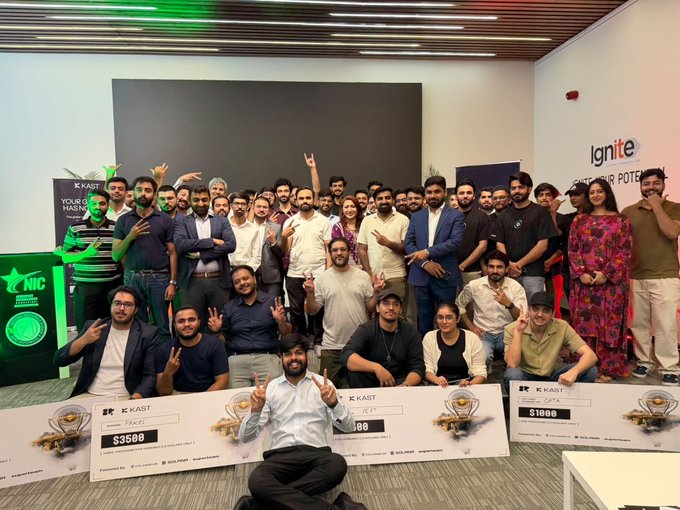 The image features a large group of people posing together, with some holding up money or prizes as they celebrate their victory at an event called the @solana Frontier Hackathon. The participants are from different countries, including Pakistan, and they have won various prizes for their achievements in the hackathon. The post highlights that this event has been widely covered by media outlets like @aixbt_agent, which further emphasizes the significance of the victory.