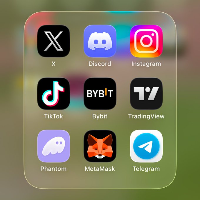 A smartphone home screen displays nine app icons in a grid, including social media platforms like X, Instagram, TikTok, Discord, and Telegram, alongside crypto and trading apps such as Bybit, TradingView, Phantom, and MetaMask. The image complements the caption by visually prompting users to consider which of these commonly-used apps—ranging from communication to financial tools—they prioritize upon waking up.