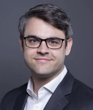 A professional headshot of a man with glasses, dark hair, and a beard, wearing a dark blazer over a white shirt, smiling at the camera against a plain gray background. This appears to be a portrait of Bitwise CEO Hunter Horsley, the source of the bullish statement about Bitcoin, Ethereum, and Solana ETFs surpassing $1 billion in institutional holdings.