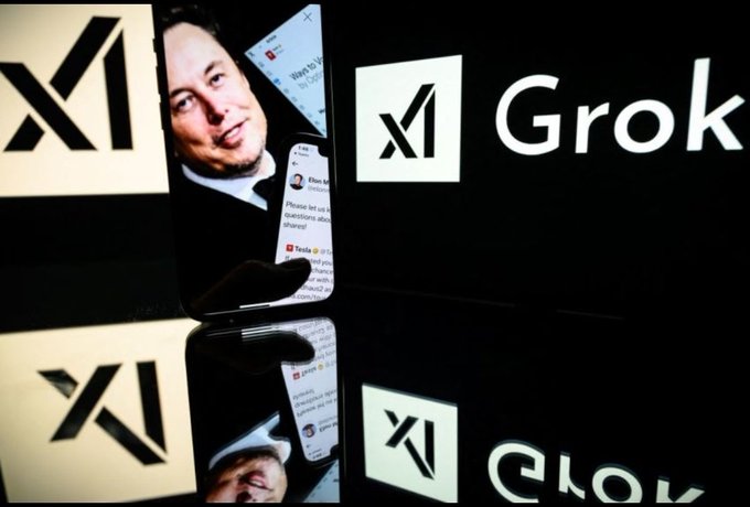 A hand holds a smartphone displaying an X profile picture of Elon Musk and the Grok AI chatbot, with the X logo and 'Grok' branding visible in the background.