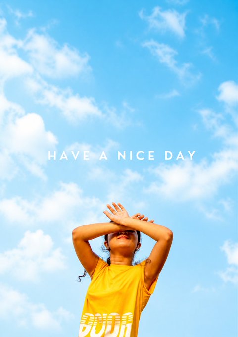 A person in a yellow shirt stands with arms raised against a blue cloudy sky, with the text 'HAVE A NICE DAY' displayed in the center.