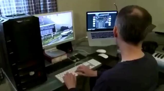 The image shows a man sitting at a desk with two computer monitors, one of which has an open laptop connected to it. The man appears to be focused on his work or gaming activities, possibly mining for bitcoins. The photo also includes text that reads "This guy was mining 1 bitcoin per day in 2013". This suggests the image might have been taken during a specific period when the man was actively mining Bitcoins.