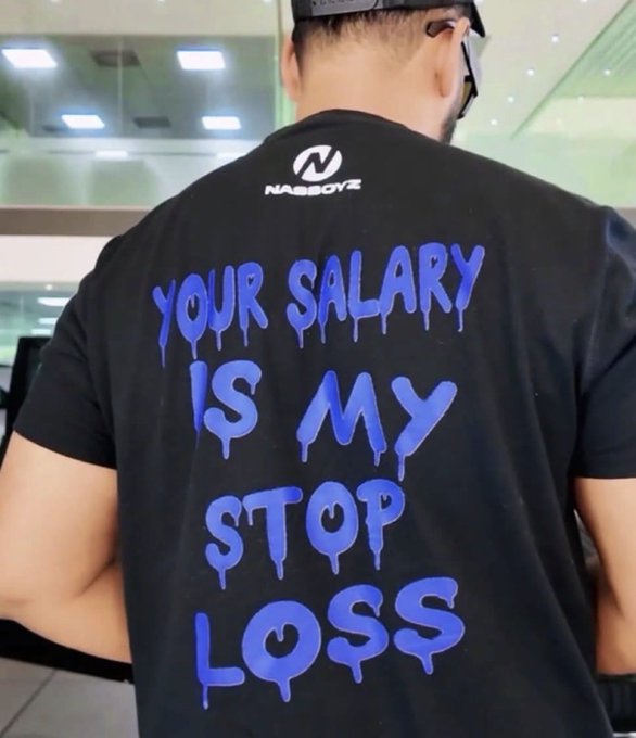 A man wearing a black t-shirt with blue dripping text that reads "YOUR SALARY IS MY STOP LOSS", branded with the Nasboyz logo at the top.