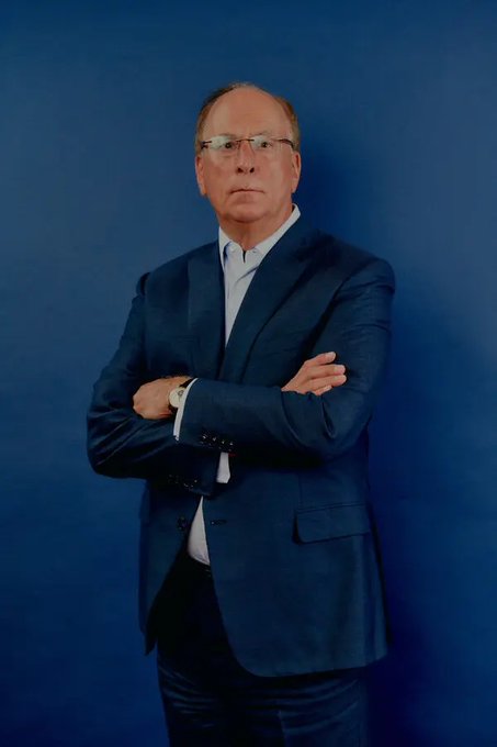 A man wearing glasses stands with his arms crossed against a blue wall, possibly posing for an image. The photograph contains a caption that reads "Only BlackRock'S IBIT ETF Has Sold 4,839.8224 $BTC Worth 5.4 Billion In The Last 4 Weeks. That's Equivalent To Roughly 4 months Of New Bitcoin Supply Being Sold Into The Market In Just 4 weeks. And people Are Still Wondering Why Bitcoin Is Under Pressure." This image has a connection to the post about IBIT ETF and Bitcoin, as it suggests that people are still curious or surprised by the current state of Bitcoin's value.