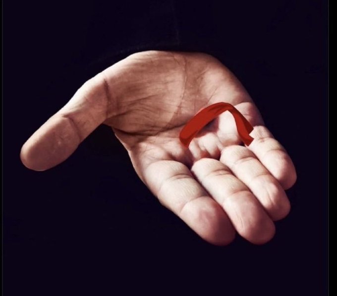 An open palm holding a small red ribbon against a dark background. The post references ticker symbol "$RKC" with the poster expressing confidence in the investment, and the red ribbon in the hand may symbolize their "hold" or conviction in the stock.