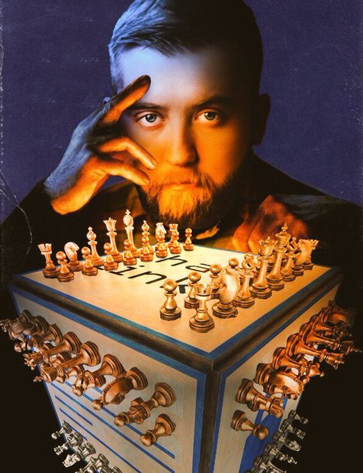 A bearded man stares intensely over a chessboard, with the wooden chess pieces creatively appearing to spill out and float below the board in a surreal composition.