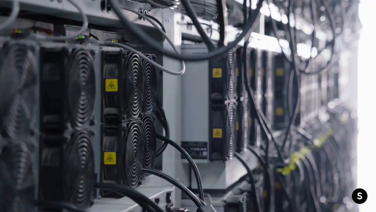 The image shows a close-up view of numerous black computer fans mounted inside a server room or data center. The fans are connected by wires, indicating that they are part of an intricate network system. The focus of the image is on these fans, which can be seen in various positions and angles within the frame. The post about Bitcoin's real breakthrough suggests that it has addressed a problem faced by computer scientists before - creating a digital currency that can't be duplicated endlessly or easily replicated. This unique feature sets Bitcoin apart from traditional forms of money and makes it an interesting subject for discussion, as it challenges conventional ideas about currency and financial systems.