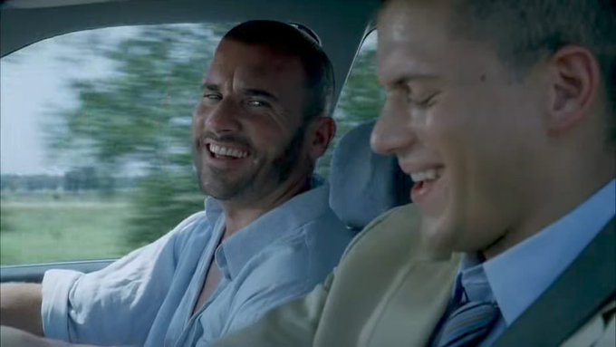 Two men are joyfully laughing while riding in a car. The image appears to be a scene from a movie or show, relating to the post's theme of circumventing restrictions.