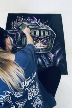 The image features a woman sitting on the floor, drawing or painting a picture of a robot with purple armor. The art piece represents everything she felt discovering @0xAlphaGEMs for the first time. Chaos. Identity. Loyalty. Energy. Dominance after finally getting an invite from @CrypSaf I’ve had nothing but huge respect for the culture and community he has built. That same".