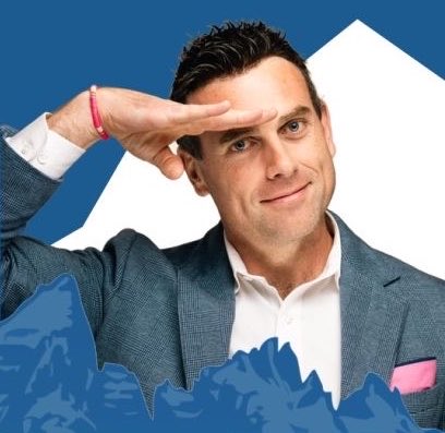 A confident man in a blue checkered blazer shields his eyes to scan the horizon, framed against a blue and white background with a red bracelet on his wrist, evoking the post's vision of having Andrew McMarkets join Jim Cramer to spotlight Chainlink's role as critical infrastructure in tokenization and digital finance.