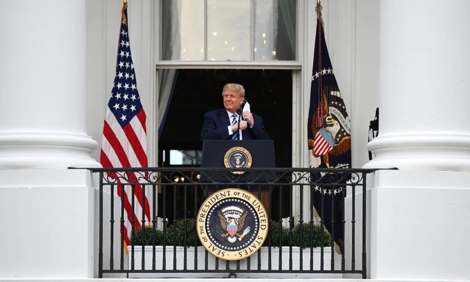 Donald Trump stands at the White House podium holding up a Bitcoin, following the White House's confirmation of the U.S. Strategic Bitcoin Reserve containing 328,372 BTC worth approximately $25 billion.