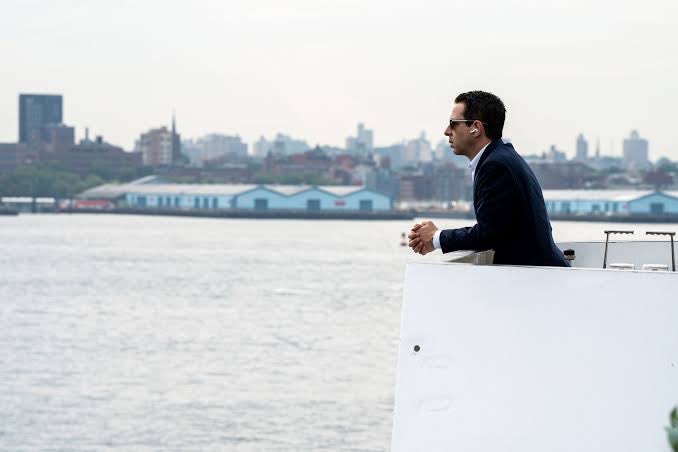 The image features a man wearing sunglasses, standing near a boat or yacht with his back to the camera. He appears to be looking out over the water, possibly enjoying the view of the city skyline in the background. The caption "deni the most cracked person on solana" is likely an inside joke or reference to Deni the Most Cracked Person on Solana, a popular YouTuber known for her unique and sometimes controversial content.

The image also contains some text that reads "focus on what is in the image". This could be a caption from the post itself or another piece of information about the photo being shared.