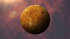 A planet rendered in orange and yellow hues floats in a purple and pink cosmic space background.