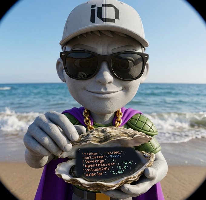 A surreal image of a gray stone-like statue character wearing sunglasses, a purple cape, and a cap with an 'iO' logo, holding an oyster on a beach that displays code reading '{ticker: 'io:PRL', delisted: True, leverage: 3, openInterest: '0.0', volume24h: '0.0', oracle: '1.44}'.