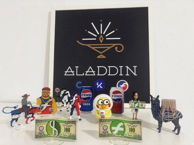 An “ALADDIN” display with collectible figures, FXNSI-themed cans, oversized novelty currency, and characters including a Minion and a woman holding money.