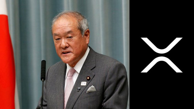 The image shows a Japanese official speaking at a podium with a Japanese flag in the background, paired with a stylized "X" logo (XRP symbol) on a black panel to the right. The composition juxtaposes the formal political figure with the cryptocurrency branding, visually supporting the claim about Shinsei Bank and a massive $115 billion XRP reward for savers.