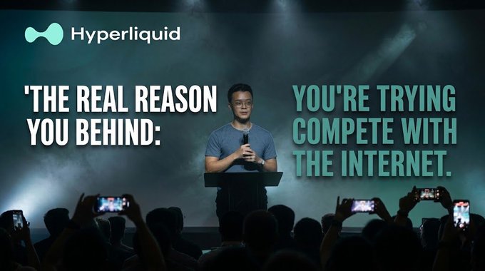 A man in a blue shirt speaks on stage at a Hyperliquid event, with large text reading 'THE REAL REASON YOU BEHIND: YOU'RE TRYING TO COMPETE WITH THE INTERNET.' and an audience filming him on their phones.