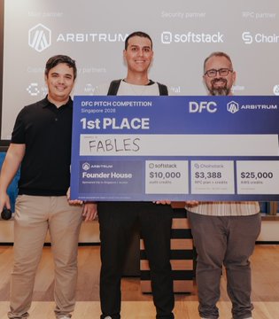 Three men posing with a large novelty check reading 'DFC PITCH COMPETITION 1st PLACE FABLES' awarded by Founder House, Softstack, and Chainlink.