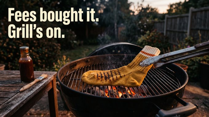 A single yellow sock with brown stripes is being grilled over hot coals on a charcoal barbecue, held by metal tongs, with the text "Fees bought it. Grill's on." displayed in the upper left. The image cleverly visualizes the post's announcement of using launchpad revenue to buy back and burn 1% of the sock supply, depicting the literal "burning" of tokens.