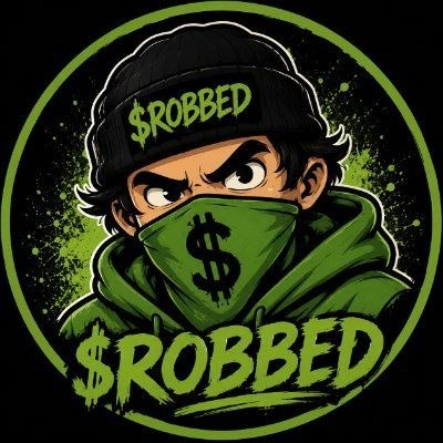 A cartoon illustration shows a masked figure wearing a black beanie reading "$ROBBED" and a green bandana featuring a dollar sign, with the bold word "$ROBBED" displayed prominently at the bottom, all set against a green circular splash background. This mascot-style graphic ties into the post's theme by visually representing the crypto community's shared feeling of being "robbed" through market losses, while promoting the $ROBBED token's community-driven branding.