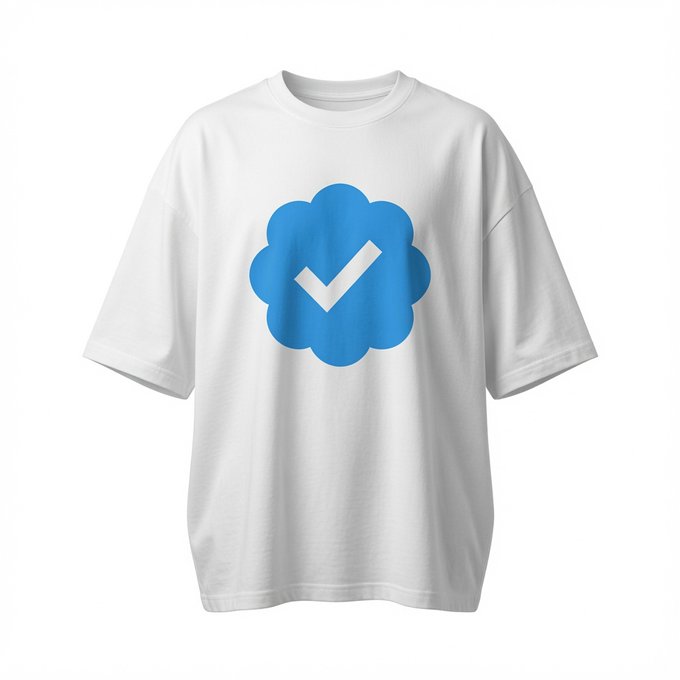 White t-shirt displayed on a plain background featuring a large blue cloud-like shape with a white checkmark in the center.
