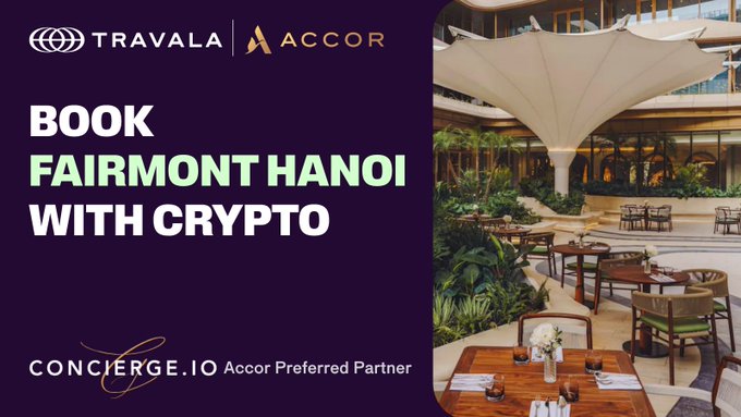 Promotional banner for booking Fairmont Hanoi with crypto via Travala, featuring the Travala and Accor logos at the top, "BOOK FAIRMONT HANOI WITH CRYPTO" text, and the Concierge.io Accor Preferred Partner logo, alongside a photo of the hotel's elegant open-air dining area with a striking white canopy and lush greenery.