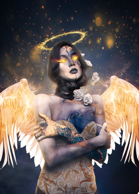 A fantasy digital artwork of a female figure with glowing yellow eyes, a golden halo, and radiant angel wings, wearing a patterned white and gold dress adorned with white flowers.