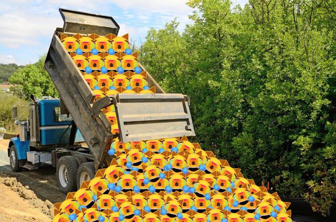 A dump truck unloads a massive pile of colorful Gmog emoji-shaped figurines—yellow bodies with blue hats and red noses—onto a dirt clearing near some trees, humorously delivering the toys "to all of Gmog's cousins" as promised in the post.