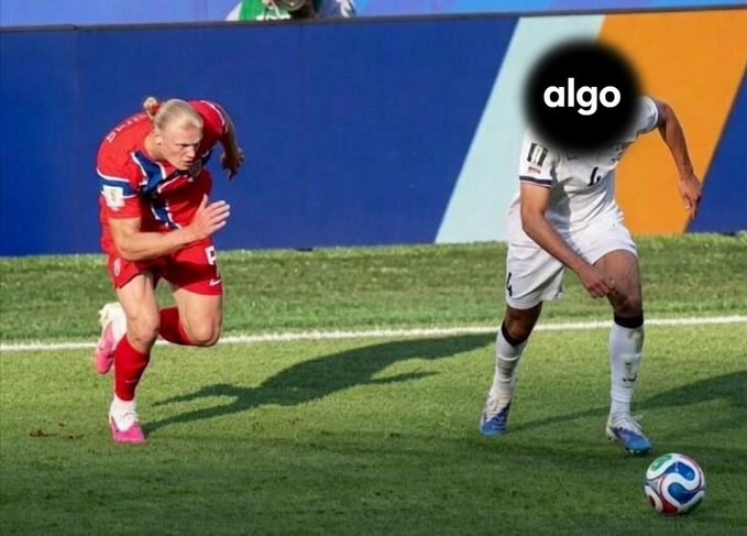 Two soccer players compete on a field, with one in a red uniform running and another in a white uniform (#6) chasing a soccer ball; the word 'algo' appears on the screen.