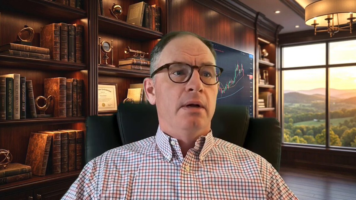 The image features a man sitting in an office chair, wearing glasses and looking at something off-camera. The background of the image shows a bookshelf filled with numerous books, suggesting that he might be working or studying in this environment. The caption provided for the image reads "DO NOT Do These Three Things: XRP Lessons Watch The Full Youtube Video Here: youtu.be/MHXNP_VtQJY Not Financial Advice". This message is likely related to a video about Ripple Coin, which could be an interesting topic of discussion or learning opportunity in this office setting.
