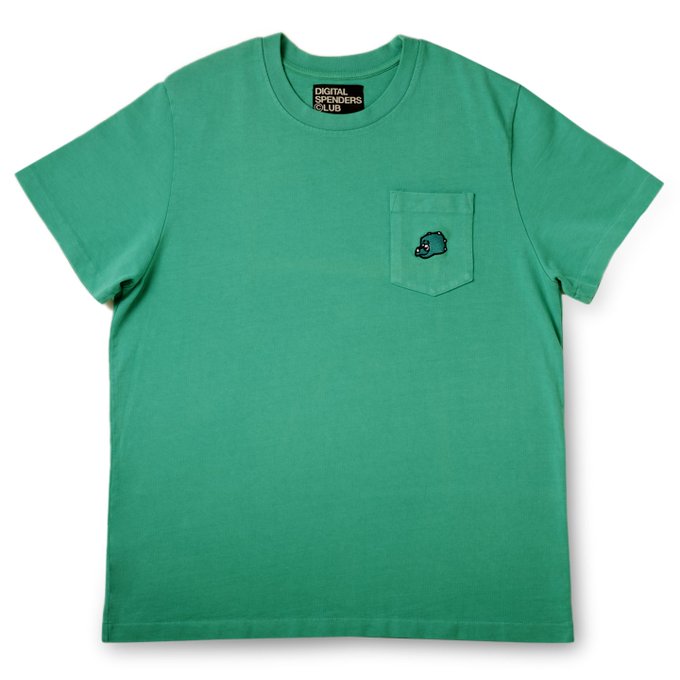 A green short-sleeve t-shirt with a chest pocket featuring a small monster logo, with a 'DIGITAL DROPOUTS CLUB' tag inside the collar.