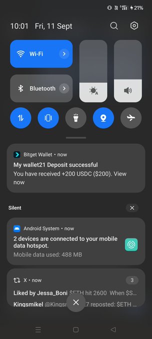 A smartphone screenshot showing the Android notification panel with a Bitget Wallet notification stating 'My wallet21 Deposit successful! You have received +200 USDC ($200)', along with Wi-Fi, Bluetooth, and other system notifications.