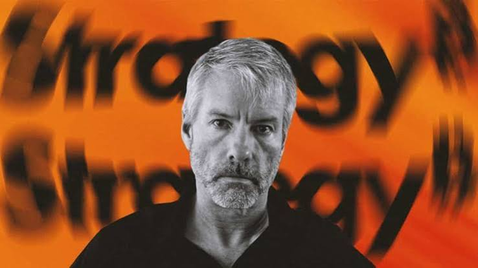 A black-and-white portrait of a serious-looking man with gray hair and a beard, set against a vibrant orange background with the blurred text "Unrealogy."