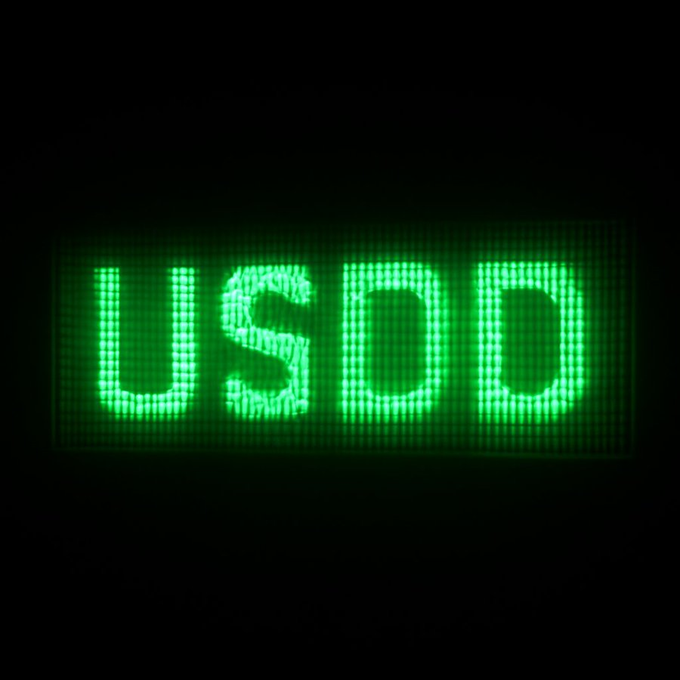 The word 'USOD' is illuminated in bright green LED-style lights against a black background.