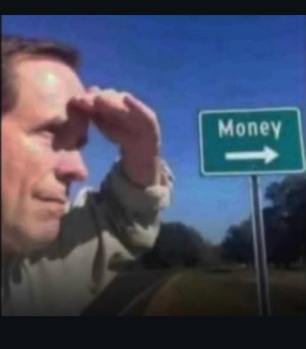 A man peers into the distance next to a road sign reading 'Money' with an arrow pointing right, a popular meme implying focus on wealth.
