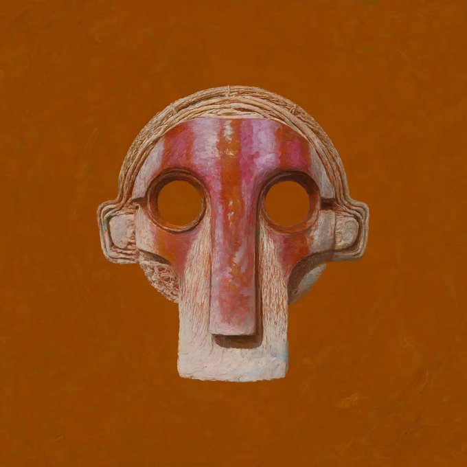 A stylized, sculpted mask or face with large round eyes, a long nose, and a pink and white striped upper section, set against a solid orange background.
