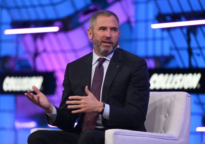 Ripple CEO Brad Garlinghouse speaks at the Collision Conference (visible on the backdrop) while discussing his criticism of Strategy's Bitcoin approach, which he claims has "hurt the market."