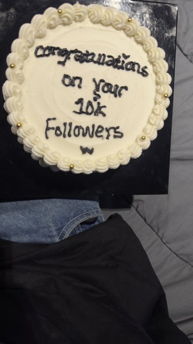 A white frosted cake with black icing reads "Congratulations on your 10k Followers" and a small "w," celebrating a social media milestone that exemplifies the real influence the recipient has built.