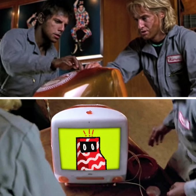 A scene from the movie Twins (1988) showing Arnold Schwarzenegger and Danny DeVito looking at a computer monitor displaying an angry cartoon character.
