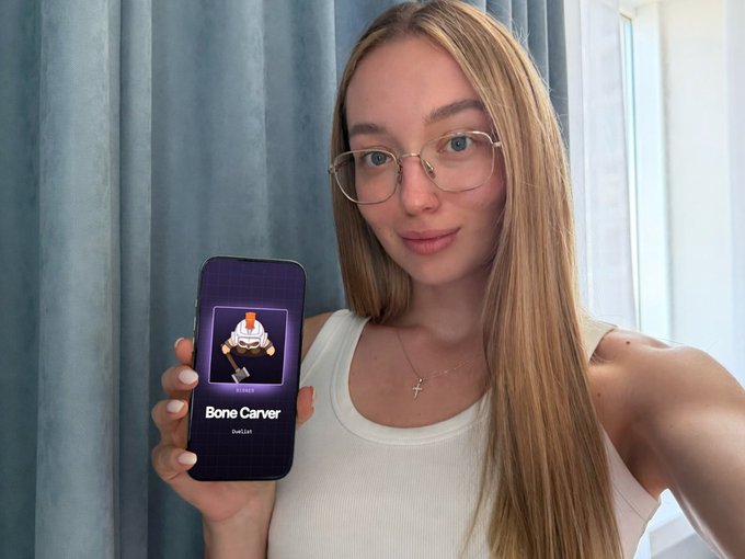 A young woman with glasses and long blonde hair holds up a smartphone displaying a "Bone Carver" card from a Solana game, promoting the Trench Royale AI battle game along with a referral link and free play codes.