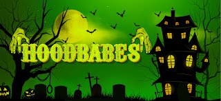 A Halloween-themed graphic featuring the text 'HOODBABES' in spooky yellow lettering against a green background with a haunted house, graveyard, and full moon.