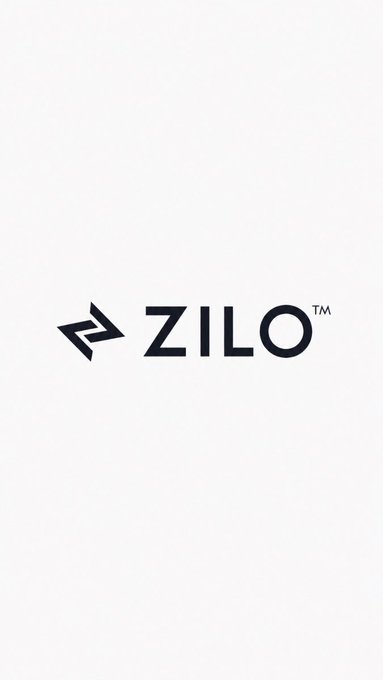 A simple logo on a white background reading "ZILO™" with a stylized geometric arrow symbol to the left of the text.