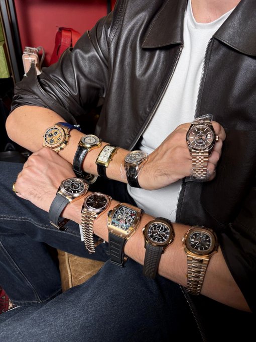A man shows off an array of luxury timepieces lined up along both of his forearms, featuring gold and steel watches with rubber and metal bracelets. His post playfully asks which is the favorite after going "a bit crazy" with the collection, perfectly matching the overwhelming wrist display.
