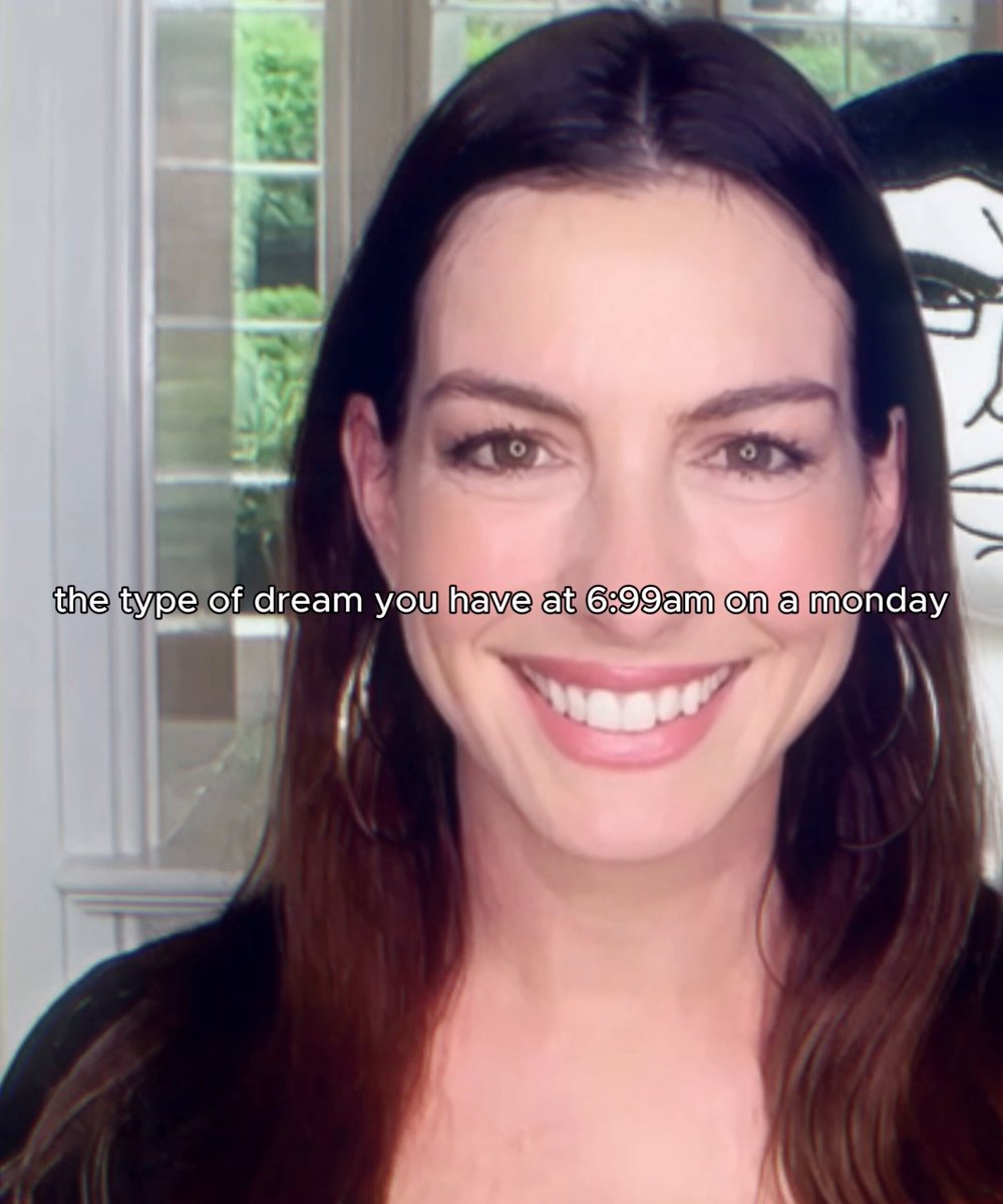The image features a woman with long brown hair wearing earrings, smiling at the camera. There are two texts present in the image that read "the type of dream you have at 6:38am on a monday" and "$neet". The woman's smile suggests she is happy or content, possibly related to her job search or personal life.