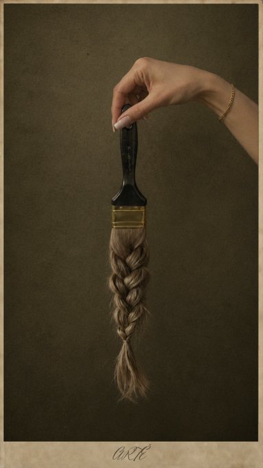 A hand adorned with a gold bracelet holds a paintbrush whose bristles have been replaced by a long, braided plait of hair, creating a surreal artwork titled "ARTÉ." The piece is presented in a vintage, sepia-toned style and is associated with a Tezos NFT collection.