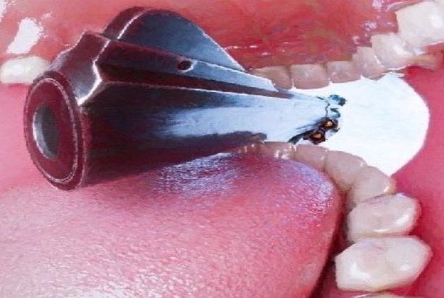 iced tea with a black straw and a small white object are visible, possibly a toothbrush or a camera lens.
