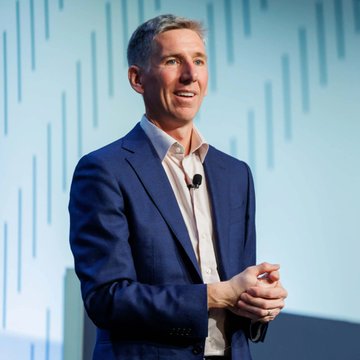 Bitwise CIO Matt Hougan, pictured here speaking at an industry event, suggested that Bitcoin could capture up to 25% of the gold market by 2035, indicating significant growth potential for the cryptocurrency.