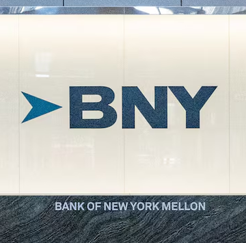 The image displays the BNY (Bank of New York Mellon) logo and name on a sleek wall, tying into the post about the $8 trillion asset custodian launching a blockchain-based digital transfer agency business aimed at reducing settlement times.