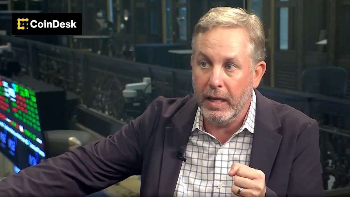 Bart Smith, CEO of Ava Labs, speaks in a CoinDesk interview setting, with the “CoinDesk” logo visible in the upper-left corner. The image illustrates his explanation of why institutions use custom Avalanche Layer 1 blockchains for KYC, AML, permissions, and connection to the broader Avalanche network.