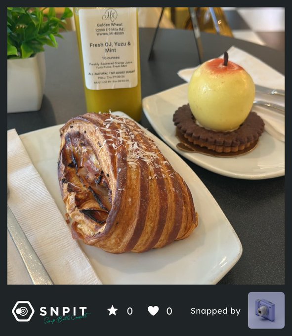 A plated meal features a bacon-wrapped dish drizzled with sauce alongside a decorative apple-shaped dessert; the 'SNPIT' logo appears at the bottom, along with 'Fresh OJ, Yuzu & Mint' from Golden Wheat on the bottle label.